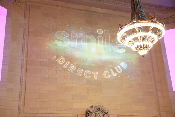 A view of wall projection during the SmileDirectClub Nighttime Clear Aligners Activation with Jordan Fisher
