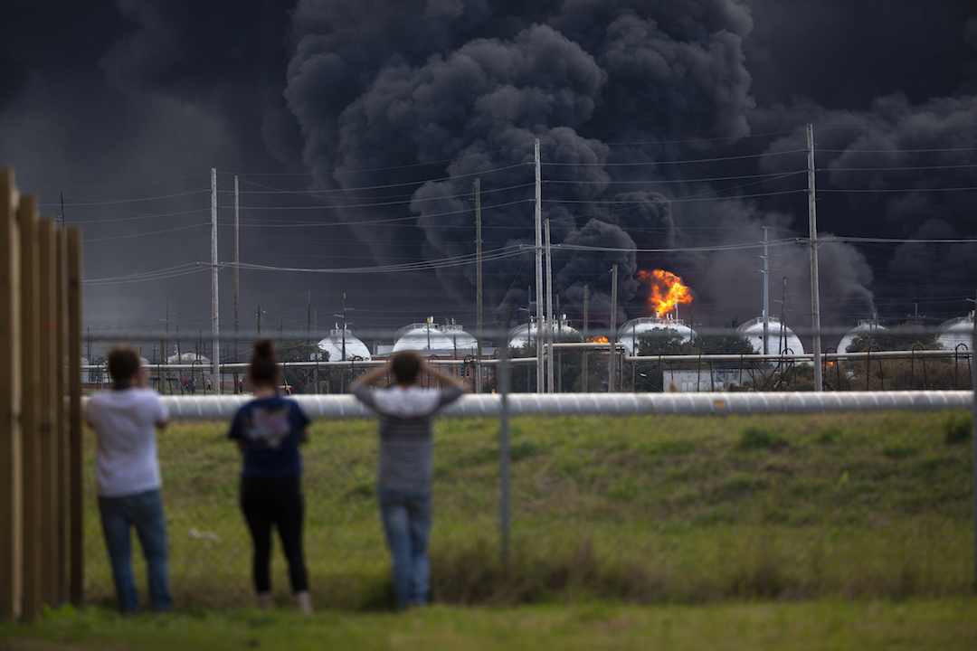 Residents observe the fire consuming the TPC Group plant in Port Neches, Texas, on Nov. 27, 2019. (Marie D. De Jesús/Houston Chronicle via AP)