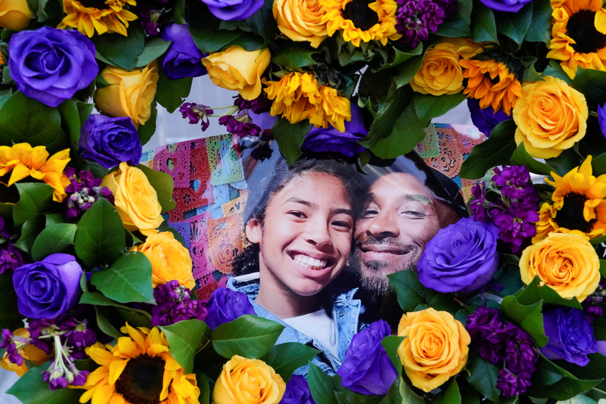Flowers and photos of Kobe Bryant and his daughter Gianna "Gigi" are placed near the Staples Center to pay tribute after a helicopter crash killed the retired basketball star and his daughter, in Los Angeles, Calif., on Jan. 28, 2020. (Kyle Grillot/Reuters)