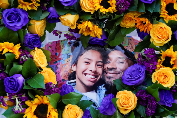 Flowers and photos of Kobe Bryant and his daughter Gianna are placed near the Staples Center to pay tribute after a helicopter crash killed the retired basketball star and his daughter, in Los Angeles, Calif., on Jan. 28, 2020. (Kyle Grillot/Reuters)