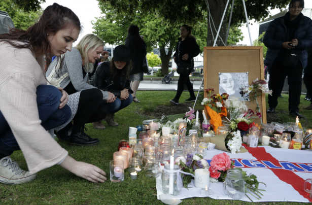 People lay flowers and light candles during a candlelight vigil for the murdered British tourist Grace Millane at Cathedral Square in Christchurch, New Zealand on Dec. 12, 2018. (AP Photo/Mark Baker/AP Photo, File)
