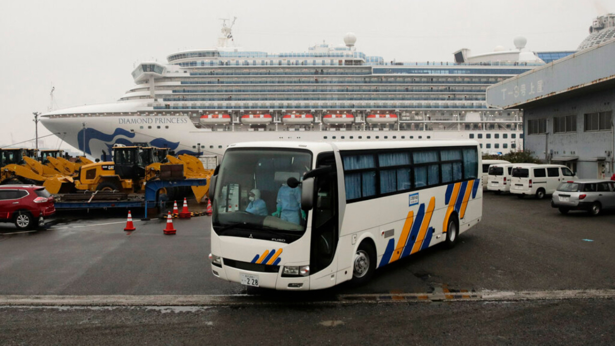 A bus leaves the quarantined Diamond Princess cruise ship at a port, in Yokohama, near Tokyo, on Feb. 16, 2020. (Jae C. Hong/Ap Photo)