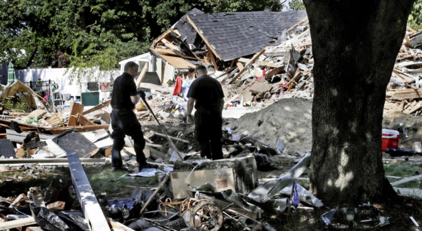 Fire investigators pause while searching the debris at a home which exploded following a gas line failure in Lawrence, Mass., on Sept. 21, 2018. (Charles Krupa/AP Photo/File)