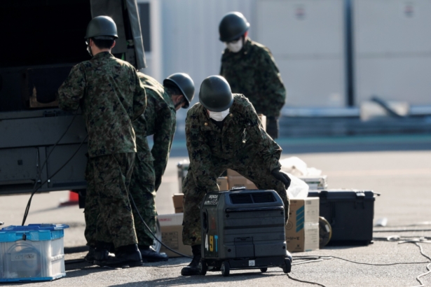 Japan Self-Defense Force soldiers work in front of the cruise ship Diamond Princess, at Daikoku Pier Cruise Terminal in Yokohama, Japan, on Feb. 13, 2020. (Kim Kyung-Hoon/Reuters)