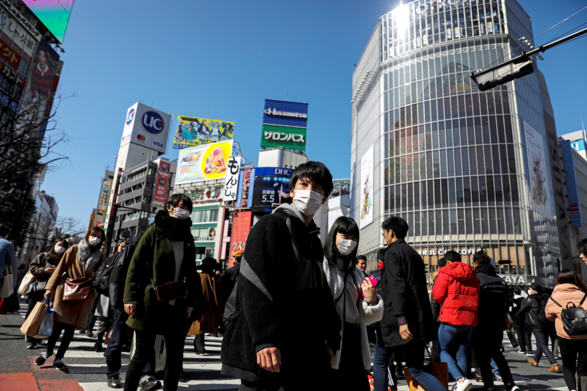 People wearing protective masks are seen in the Shibuya shopping district in Tokyo, Japan on Feb. 24, 2020. (Athit Perawongmetha/Reuters)