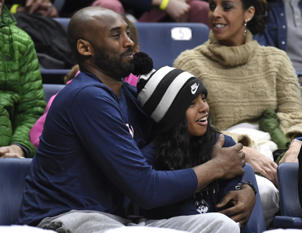 Kobe Bryant and his daughter Gianna watch the first half of an NCAA college basketball game between Connecticut and Houston in Storrs, Conn., on March 2, 2019. (Jessica Hill/AP Photo)
