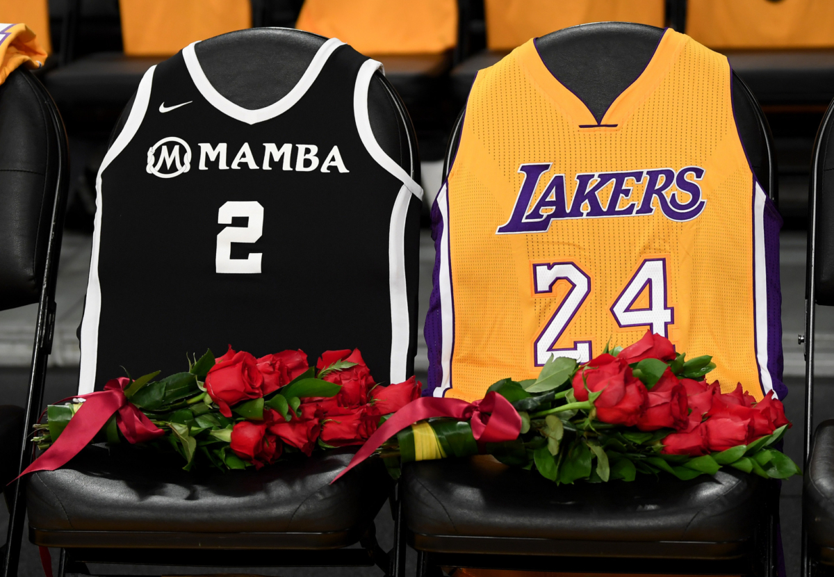 The Los Angeles Lakers honor Kobe Bryant and daughter Gigi by covering the courtside seats they occupied with flowers, Gigi's #2 Mamba jersey and Kobe's #24 jersey before the game against the Portland Trail Blazers at Staples Center in Los Angeles, Calif., on Jan. 31, 2020. (Harry How/Getty Images)