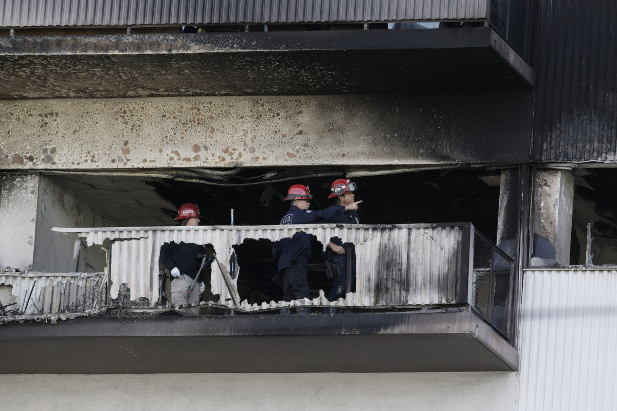 Los Angeles County Fire Arson Fire Investigation Unit investigators conduct investigations on the sixth floor of a residential building in Los Angeles on Jan. 29, 2020. (Damian Dovarganes/AP Photo)