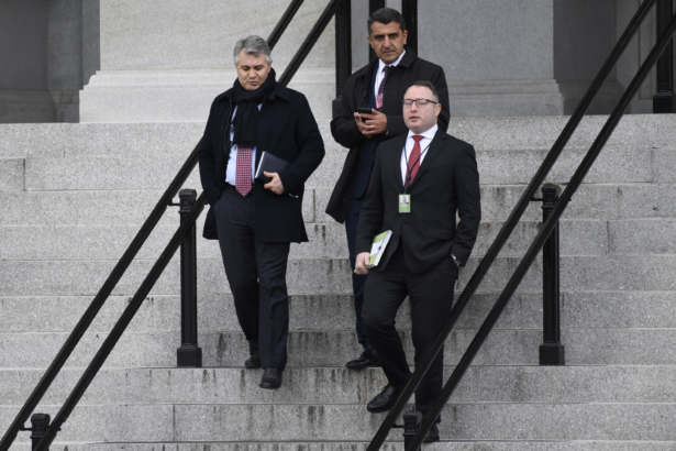 Army Lieutenant Colonel Alexander Vindman, a military officer at the National Security Council who testified during the impeachment hearings on Capitol Hill, lower right, walks down the steps of the Eisenhower Executive Office Building on the White House complex in Washington, on Jan. 27, 2020. (Susan Walsh/AP Photo)