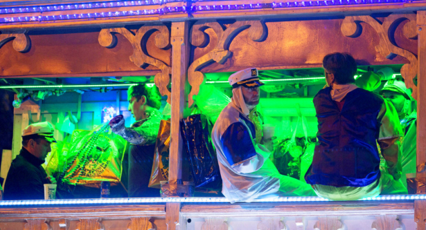 Parade participants stay on their float as police officers work the scene where a man was reportedly hit and killed by a float of the Krewe of Endymion parade in the runup to Mardi Gras in New Orleans, on Feb. 22, 2020. (Max Becherer/The Advocate via AP)