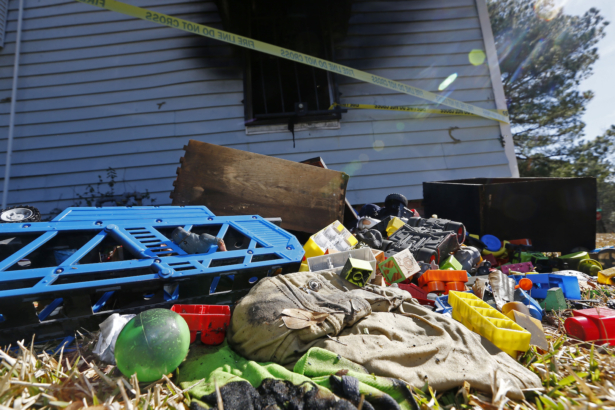 Burned children's clothing, furnishings exterior of a house at the scene of a fatal fire in Clinton, Miss. on Feb. 8, 2020.(Rogelio V. Solis/AP)