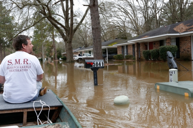 Chris Sharp studies the water damage from the Pearl River that floods his neighborhood in Jackson, Miss., on Feb. 16, 2020. (Rogelio V. Solis/AP Photo)