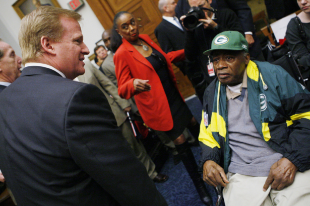 NFL Commissioner Roger Goodell (L) meets former Green Bay Packers player Willie Wood, during a House Judiciary Committee hearing on legal issues relating to football head injuries, on Capitol Hill in Washington, on Oct. 28, 2009. (Charles Dharapak/AP)