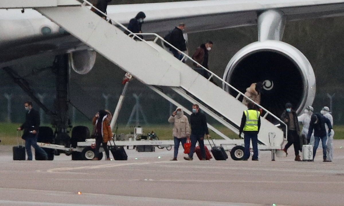 Passengers from China disembark from a plane at RAF Brize Norton near Oxford, Britain, on Feb. 9, 2020. (Peter Nicholls/Reuters/File)