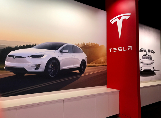 Posters showing the Tesla Model X are displayed at a Tesla showroom in Corte Madera, Calif., on Aug. 2, 2017. (Justin Sullivan/Getty Images)
