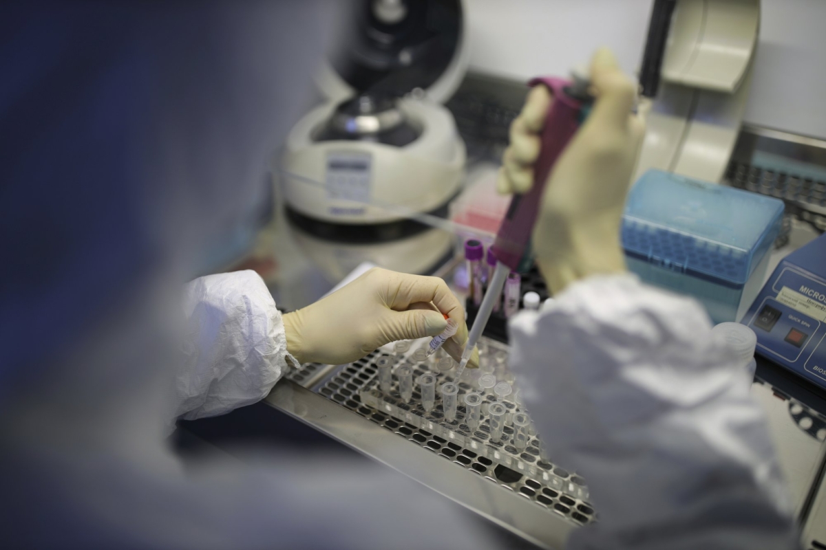 A medical staffer works with test systems for the diagnosis of coronavirus, at the Krasnodar Center for Hygiene and Epidemiology microbiology lab in Krasnodar, Russia on Feb. 4, 2020. (AP Photo)
