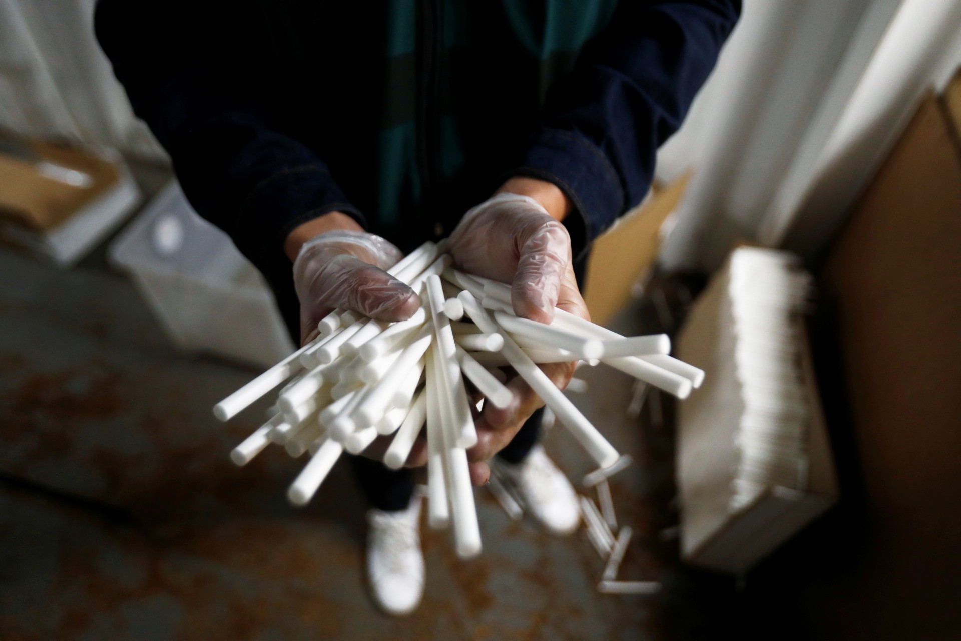A Spanish civil guard carries part of cigarettes in an illegal underground tobacco factory during a police raid in Monda, near Malaga, in southern Spain, on Feb. 20, 2020. (Jon Nazca/Reuters)