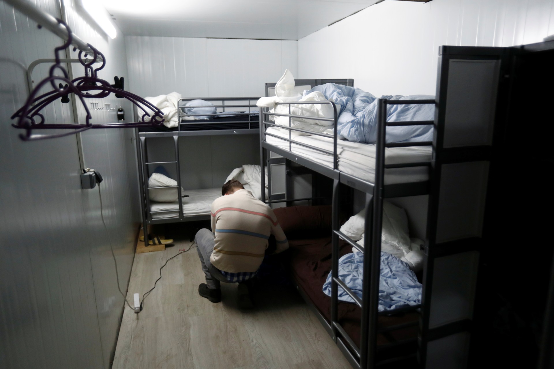 A cameraman flims in an illegal underground tobacco factory during a police raid in Monda, near Malaga, in southern Spain, on Feb. 20, 2020. (Jon Nazca/Reuters)