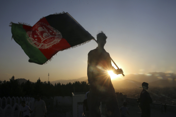 A man waves an Afghan flag during Independence Day celebrations in Kabul, Afghanistan, on Aug. 19, 2019. (Rafiq Maqbool/AP photo)