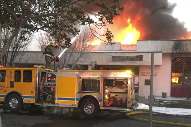 Firemen battle a fire at the public library in Porterville, Calif., on Feb. 18, 2020. (Charles Whisnand/The Porterville Recorder via AP)