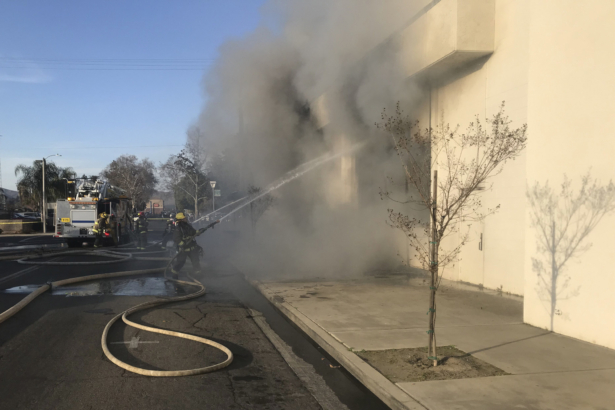 Firemen work to extinguish a fire at the public library in Porterville, Calif., on Feb. 18, 2020. (Charles Whisnand/The Porterville Recorder via AP)