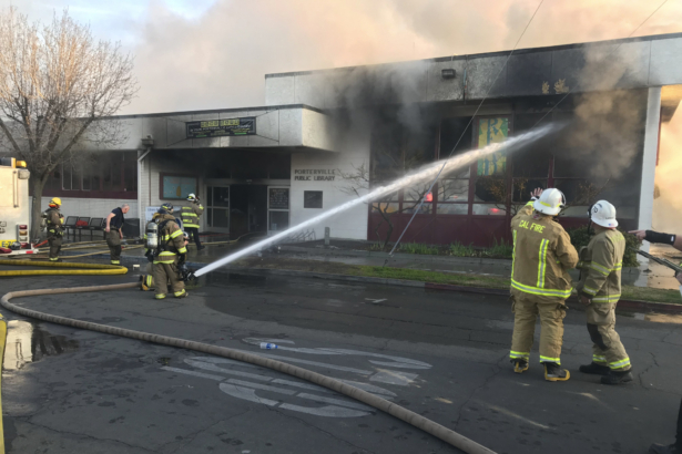Firemen work to extinguish a fire at the public library in Porterville, Calif., on Feb. 18, 2020. (Charles Whisnand/The Porterville Recorder via AP)