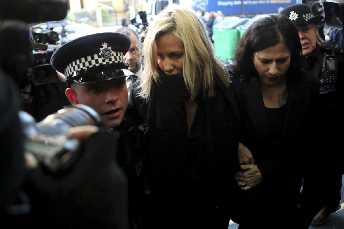 Love Island TV presenter Caroline Flack (C) is escorted by police as she arrives at court in London, on Dec. 23, 2019. (Petros Karadjias/AP Photo)