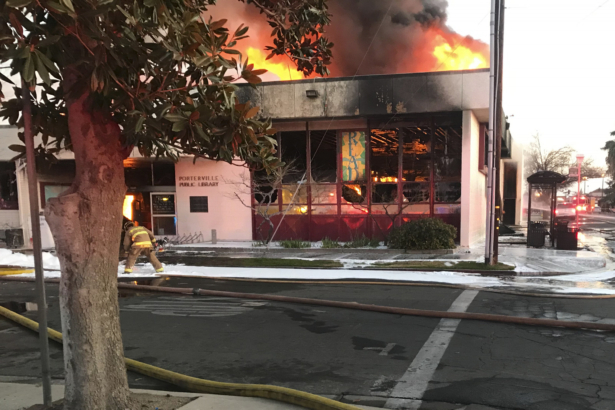 Flames engulf the public library in Porterville, Calif., on Feb. 18, 2020. (Charles Whisnand/The Porterville Recorder via AP)