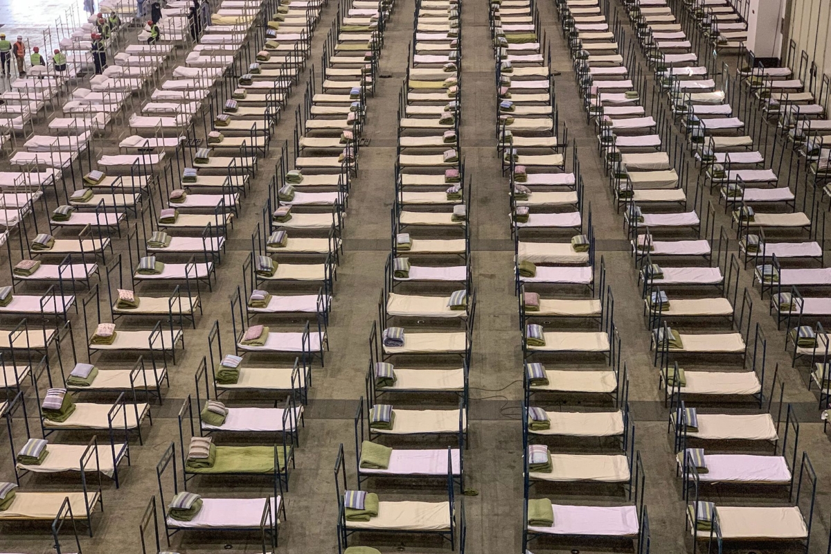 Workers set up beds at an exhibition center that was converted into a hospital in Wuhan in China's central Hubei province on Feb. 4, 2020. (STR/AFP via Getty Images)