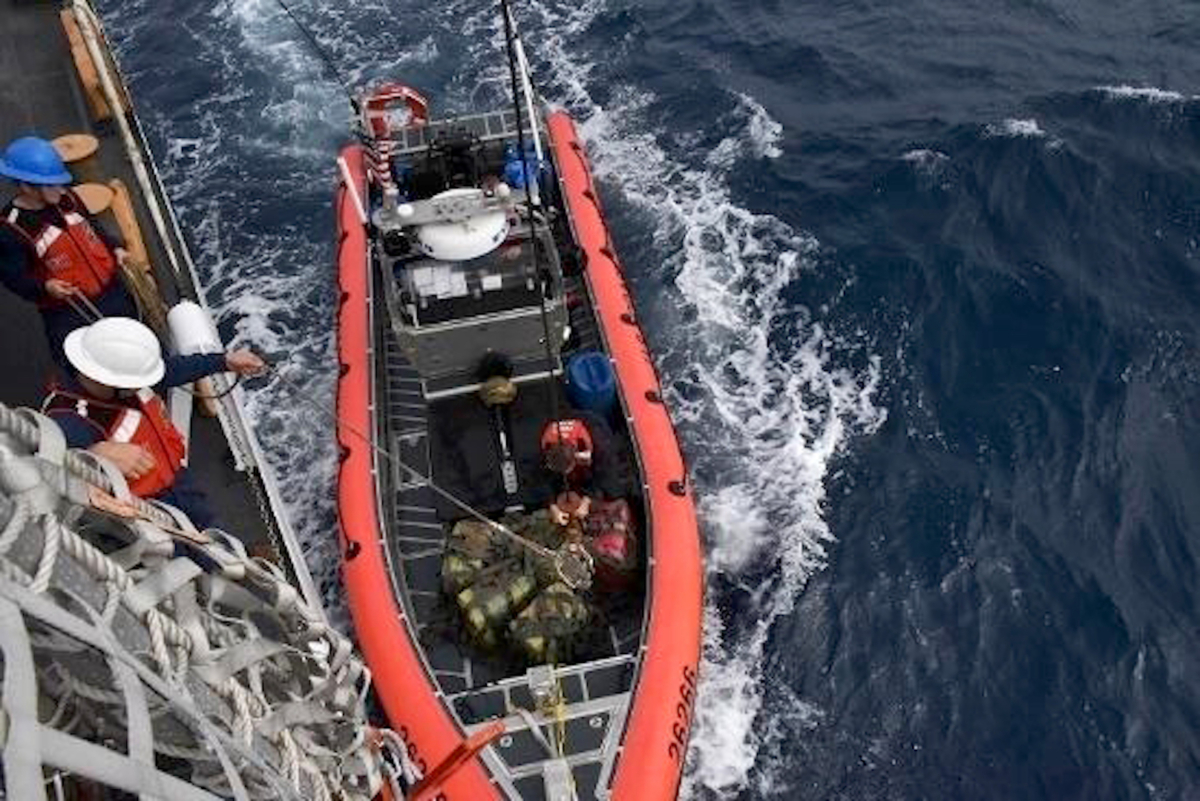 Crew members from the cutter Thetis hoist interdicted drugs seized in international waters of the Eastern Pacific Ocean, on Nov. 16, 2019. (PO1 Mark Barney/U.S. Coast Guard via AP)
