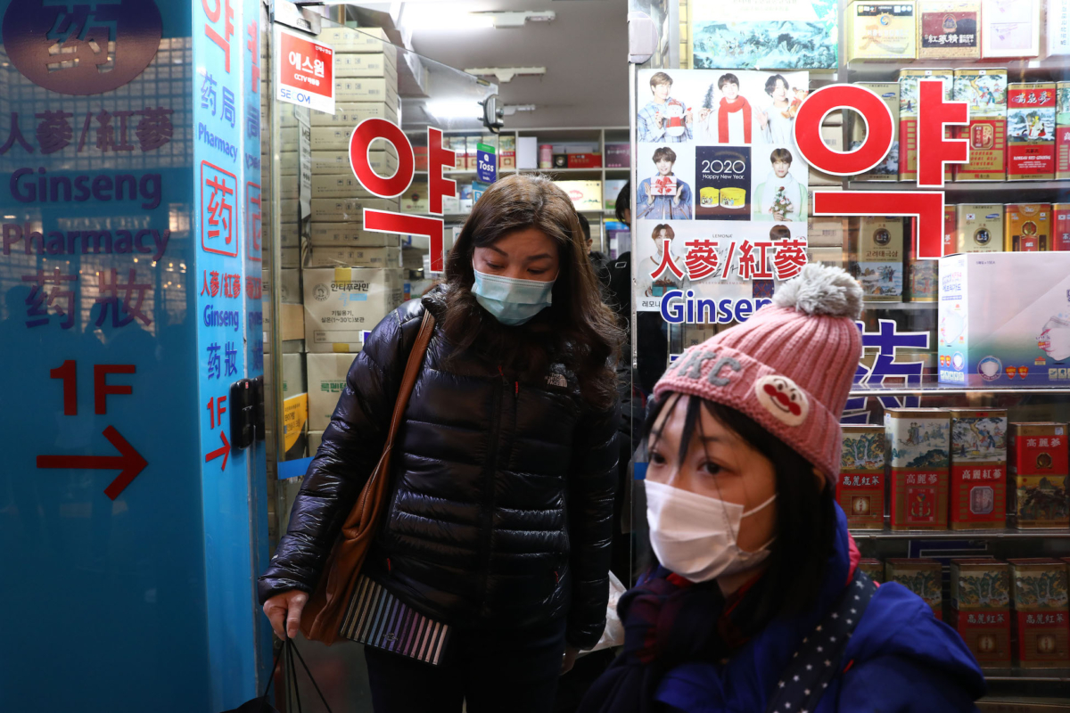 People leave after buying face masks at a pharmacy at Myeongdong shopping district in Seoul on Jan. 31, 2020. (Chung Sung-Jun/Getty Images)