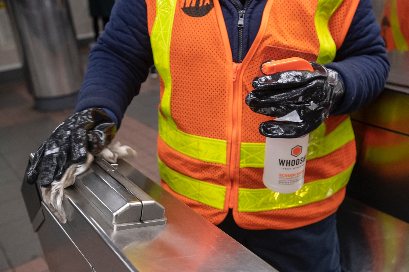 MTA worker wipes down equipment at a subway station in New York on Mar. 3, 2020. (Patrick Cashin/MTA New York City Transit)