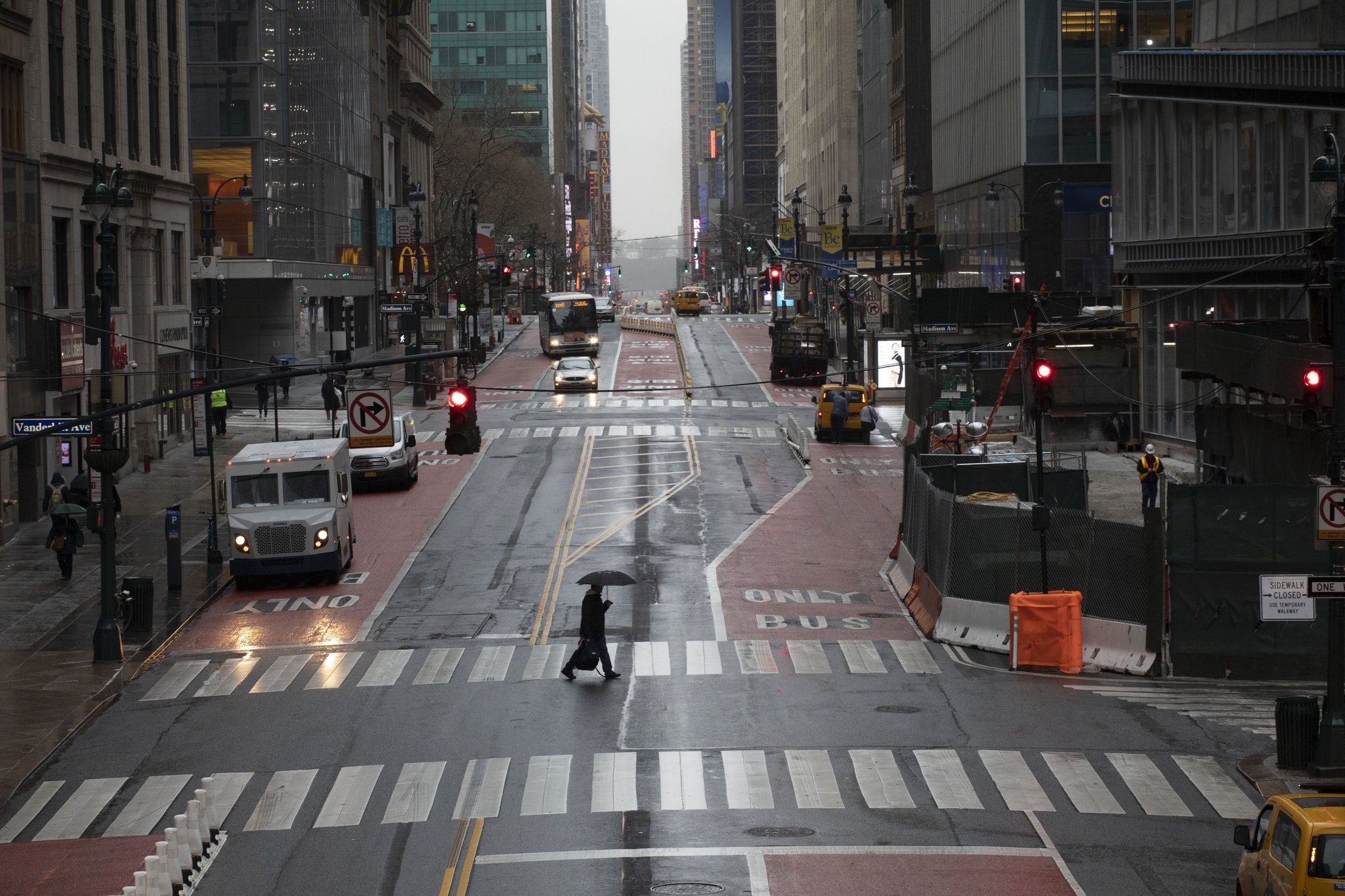 A commuter crosses 42nd Street in front of Grand Central Terminal during morning rush hour in New York, on March 23, 2020. (Mark Lennihan/AP Photo)