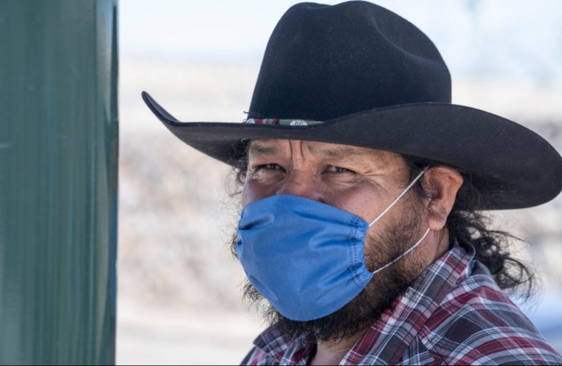 Jose Vera, 53, who is traveling to Colorado from Zacatecas, Mexico, wears a mask as a precautionary measure against COVID-19 while waiting for his bus to cross the U.S.-Mexico border in El Paso, Texas, on March 20, 2020. (Paul Ratje/AFP via Getty Images)