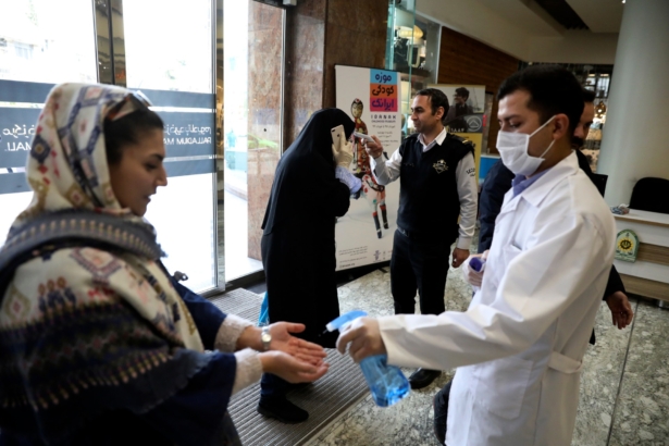 People have their temperature checked and their hands disinfected as they enter the Palladium Shopping Center, in northern Tehran, Iran, on March 3, 2020. (Vahid Salemi/AP Photo)