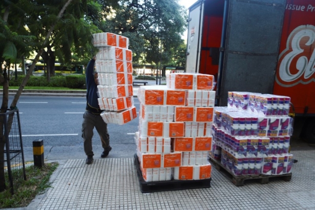 A worker unloads toilet paper packages outside a store after Argentina's President Alberto Fernandez announced a mandatory quarantine, in Buenos Aires, Argentina March 20, 2020. (Reuters/Matias Baglietto)