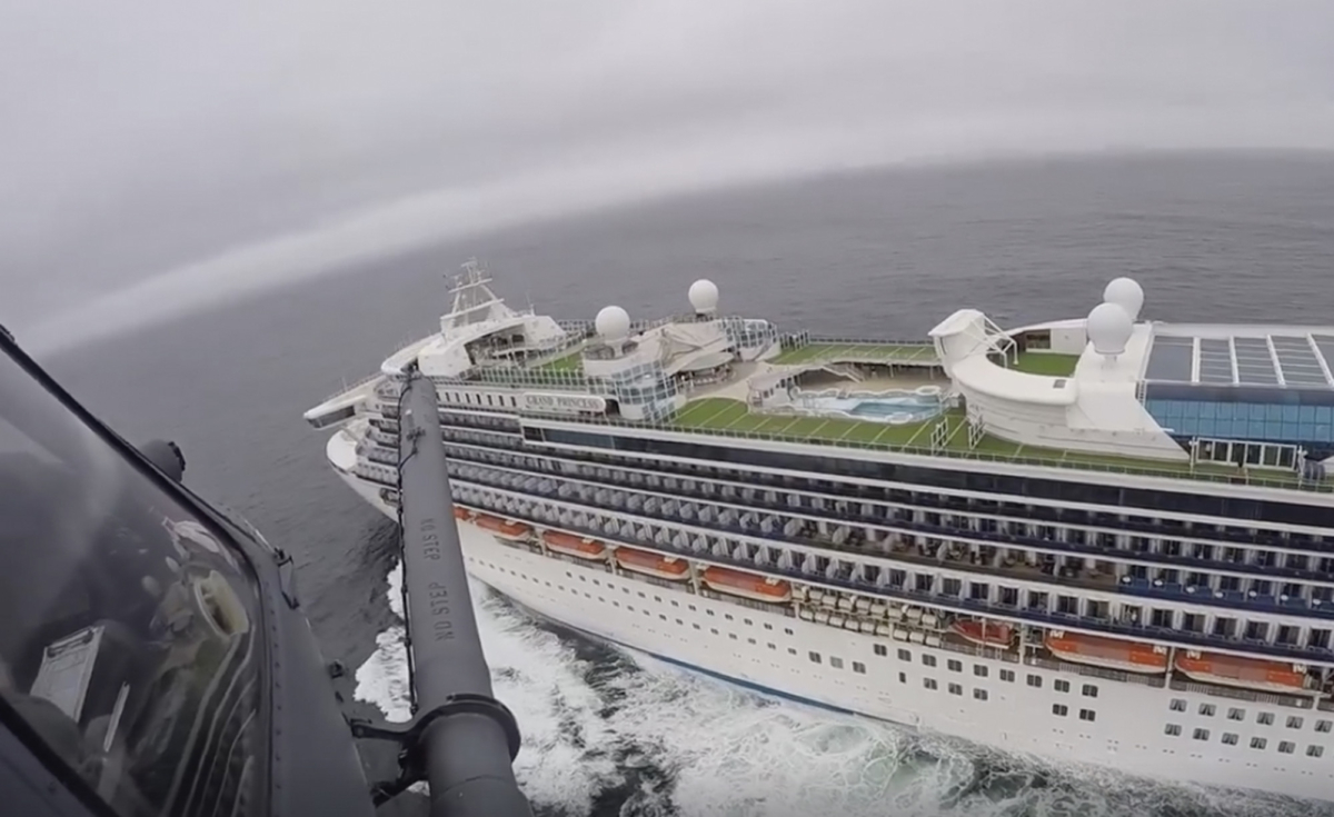 A helicopter carrying airmen with the 129th Rescue Wing flies over the Grand Princess cruise ship off the coast of California on March 5, 2020. (California National Guard via AP)