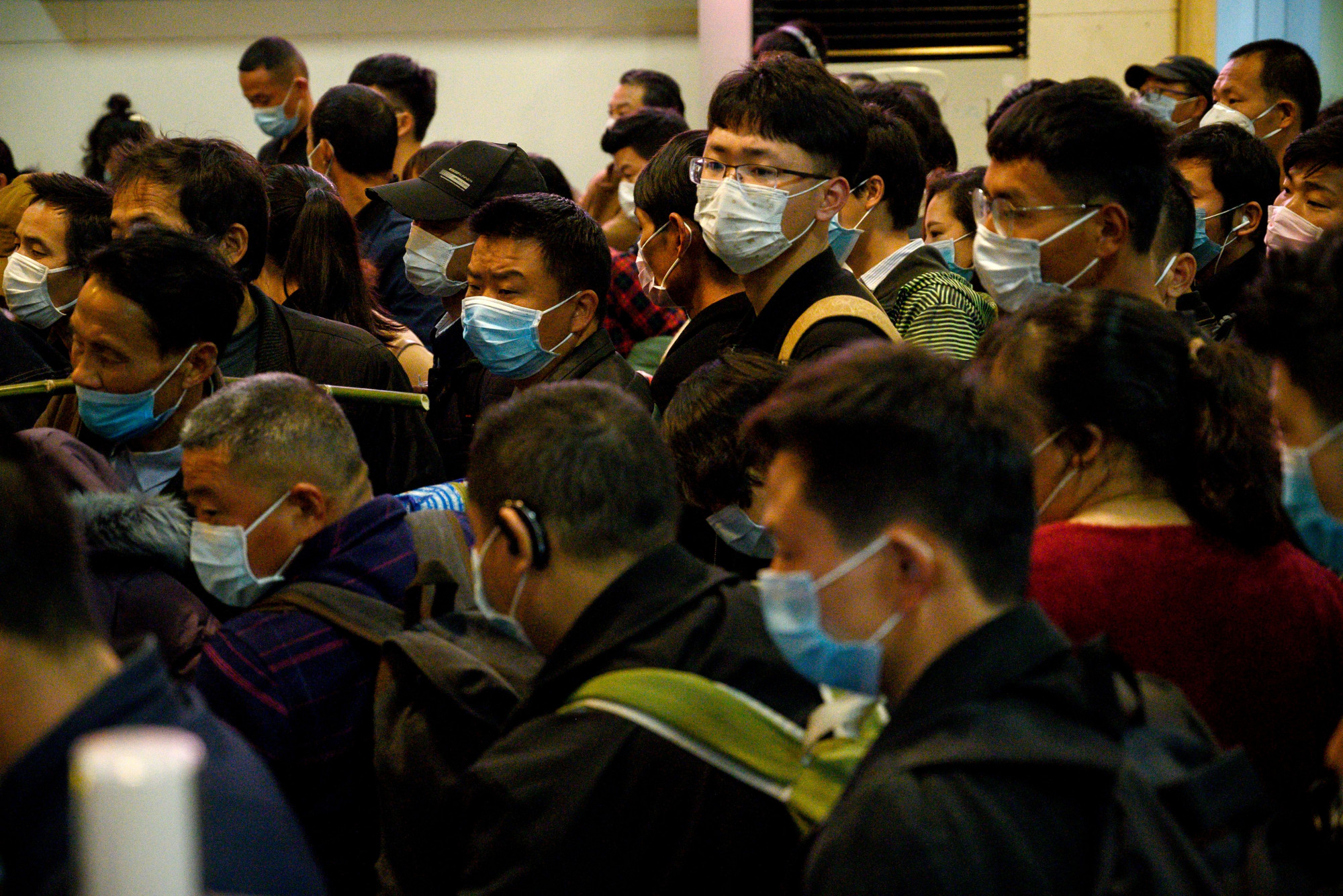Passengers wear protective masks queue as they wait for the train to arrive at Jiujiang railway station in Jiujiang, a city which sits on the border between Chinas central Jiangxi province and Hubei province, the epicentre of the country's COVID-19 coronavirus outbreak, on March 21, 2020. (Noel Celis/AFP via Getty Images)