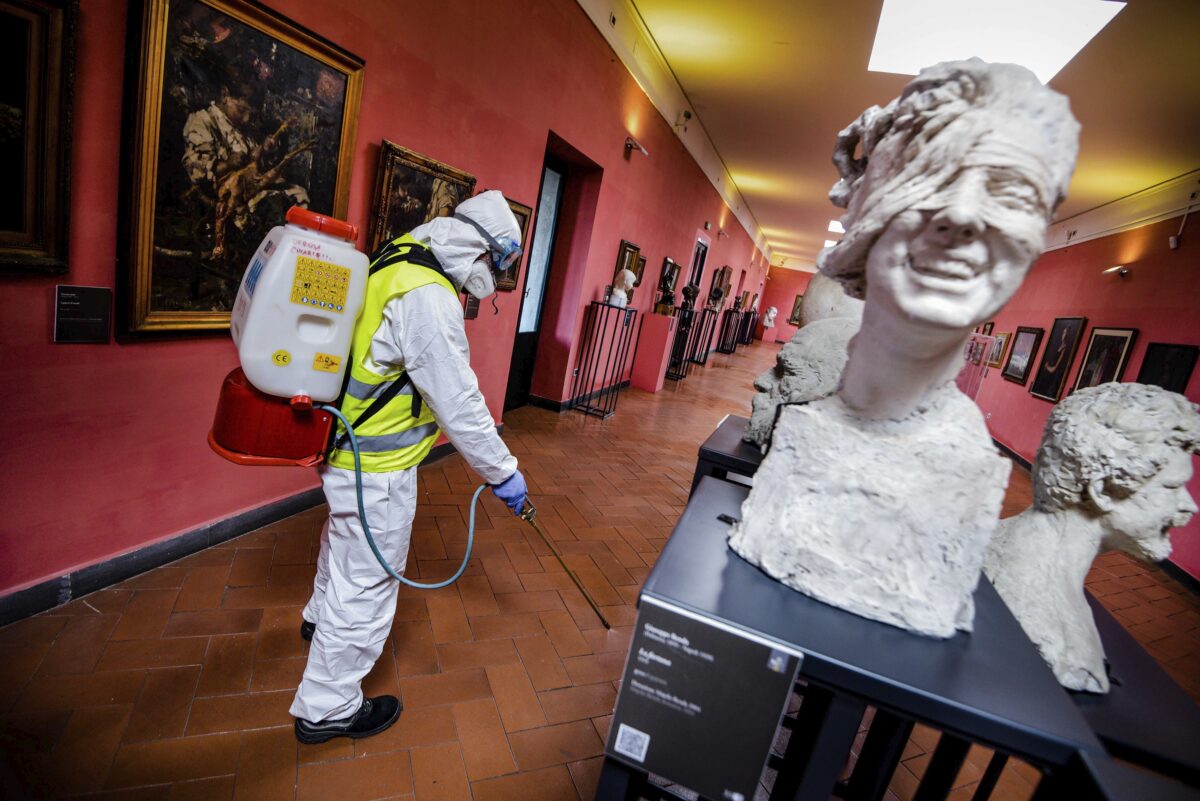 A worker sprays disinfectant as sanitization operations against Coronavirus are carried out in the museum hosted by the Maschio Angioino medieval castle, in Naples, Italy on March 10, 2020. (Alessandro Pone/LaPresse via AP)