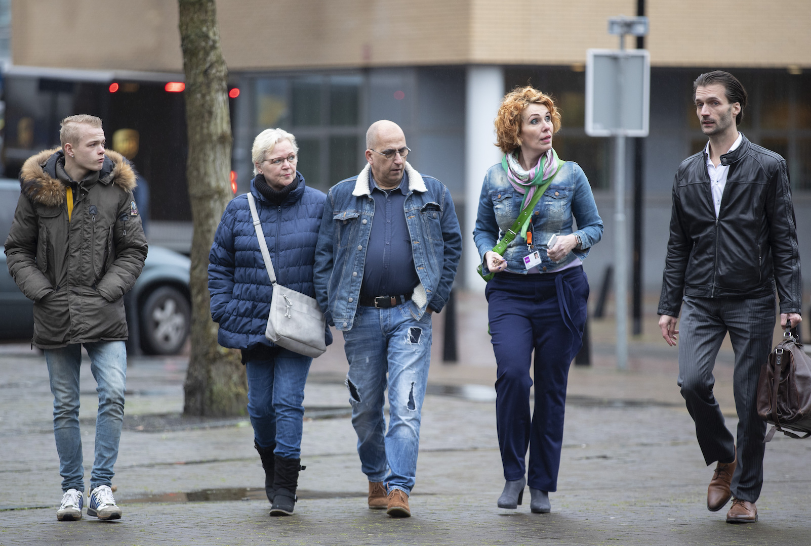 Rene Verschuur, center, father of Roos Verschuur, one of the victims of the Utrecht tram shooting, his lawyer Sebas Diekstra, right, and other family members arrive for the trial of a Dutch man of Turkish descent, at the Utrecht court, Netherlands, on March 2, 2020. (Peter Dejong/AP)