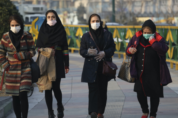 Pedestrians wearing face masks walk on a sidewalk in western Tehran, Iran, on Feb. 29, 2020. (Vahid Salemi/AP Photo)