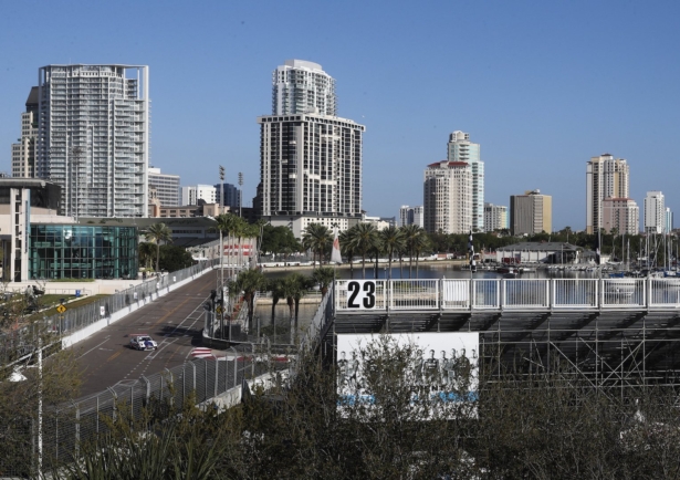 The grandstands are empty as cars make their way around past the Mahaffey Theater and head towards turn 10 during the opening day of the Firestone Grand Prix of St. Petersburg in St. Petersburg, on March 13, 2020. (Dirk Shadd/Tampa Bay Times via AP)