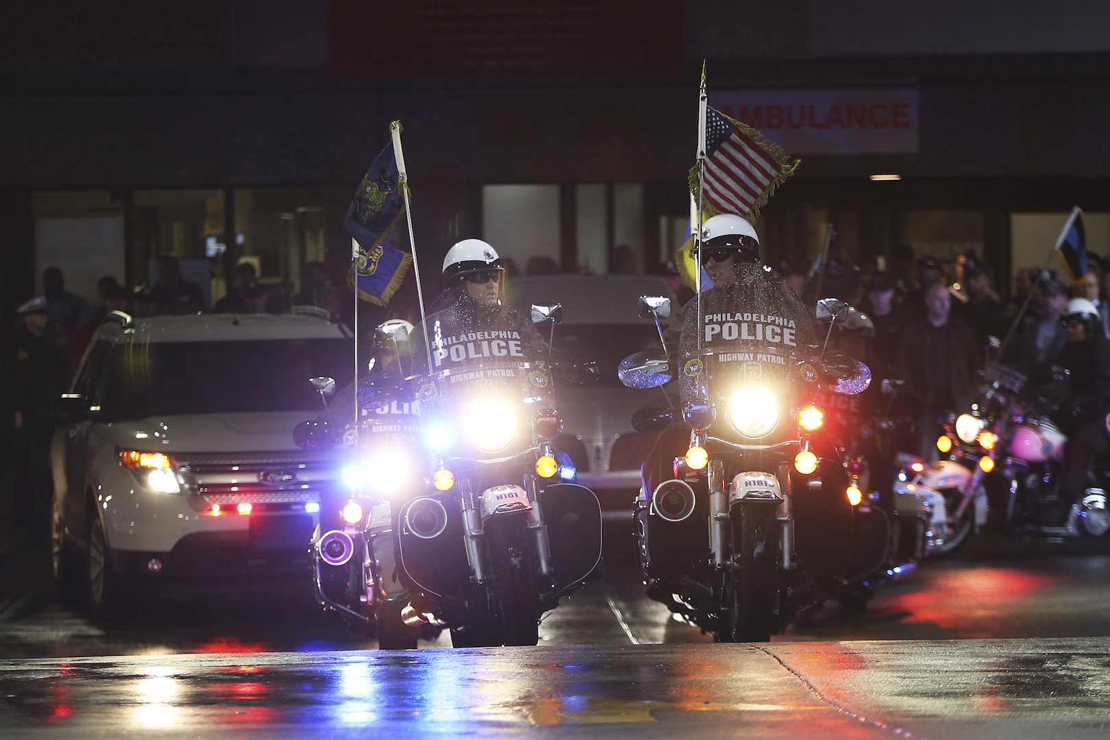 Philadelphia police highway patrol officers lead the procession after the body of SWAT Cpl. James O’Connor was brought to a hearse at the emergency room entrance at Temple University Hospital in North Philadelphia, on March 13, 2020.(Tim Tai/The Philadelphia Inquirer via AP)
