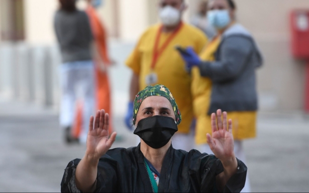 A healthcare worker acknowledges applause outside the Gregorio Maranon Hospital in Madrid on April 12, 2020. (Pierre-Philippe Marcou /AFP via Getty Images)