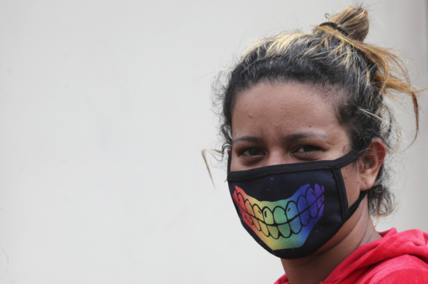 A woman wearing a decorative protective mask as a precaution against the spread of the CCP virus in Quito, Ecuador, on March 28, 2020. (Dolores Ochoa/AP Photo)