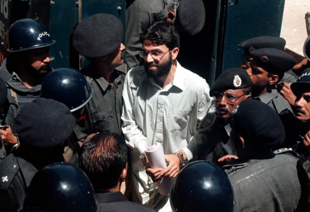 Ahmed Omar Saeed Sheikh, the alleged mastermind behind Wall Street Journal reporter Daniel Pearl's abduction, arrives at the provincial high court in Karachi, Pakistan, on March 29, 2002. (Getty Images)