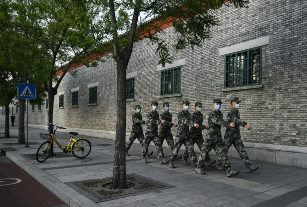 Chinese military wear protective masks as they march in the street in Beijing, China, on April 22, 2020. (Kevin Frayer/Getty Images)
