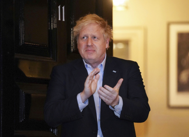 Britain's Prime Minister Boris Johnson claps outside 11 Downing Street to salute local heroes during the nationwide Clap for Carers NHS initiative to applaud workers fighting the CCP virus pandemic, in London on April 2, 2020. (Pippa Fowles/10 Downing Street via AP)