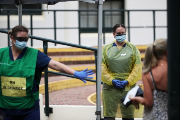 Healthcare professionals direct a woman at a pop-up clinic testing for the coronavirus disease (COVID-19) at Bondi Beach, after several outbreaks were recorded in the area, in Sydney, Australia, on April 1, 2020. (Loren Elliot/Reuters)
