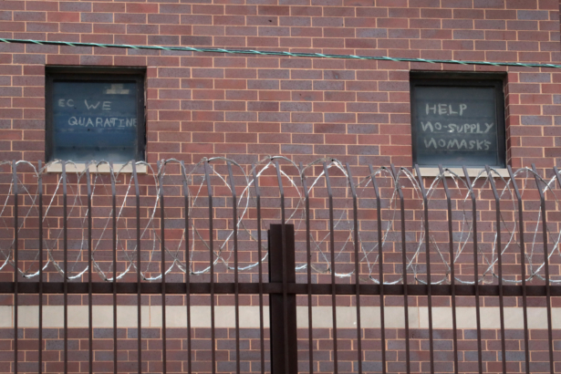 Signs pleading for help hang in windows at the Cook County jail complex in Chicago, Ill., on April 9, 2020. (Scott Olson/Getty Images)